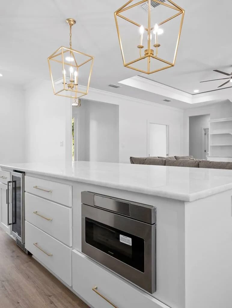 Custom kitchen island with gold pendants